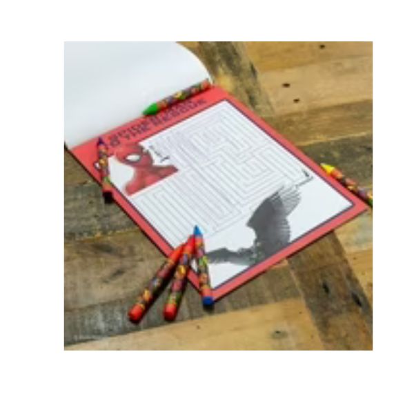 Open book with crayons on a wooden surface